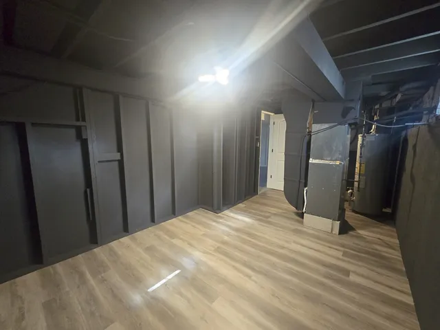 a view of a closet area with wooden floor