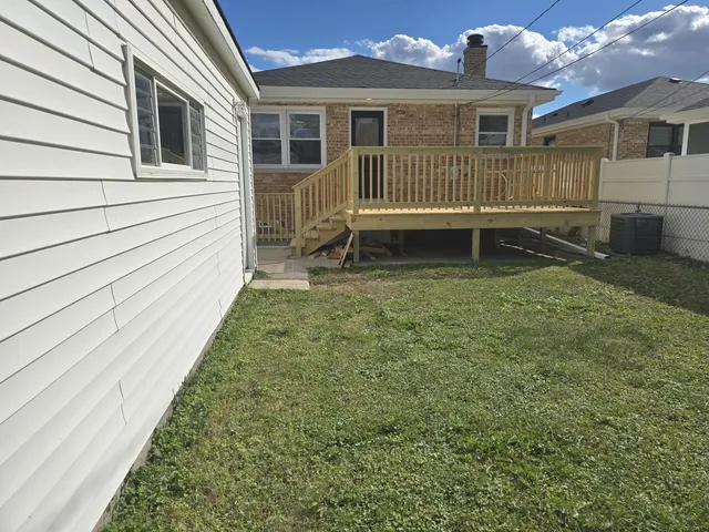 a view of a house with a yard and sitting area