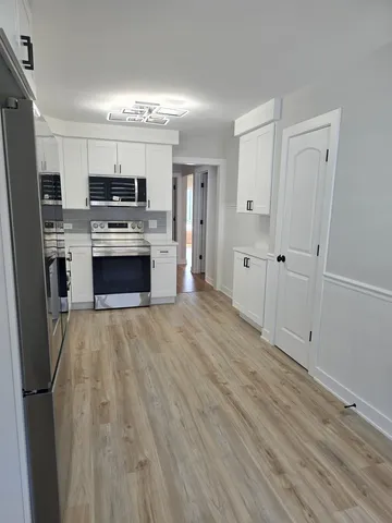 a kitchen with stainless steel appliances a refrigerator sink and stove