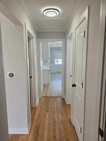 a view of a room with wooden floor