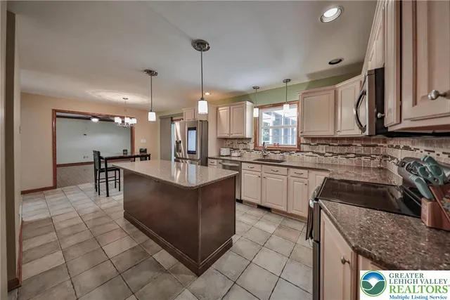 a view of a livingroom with a fireplace and window