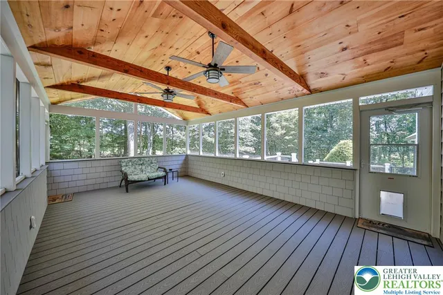 a spacious bathroom with a granite countertop sink a mirror and shower