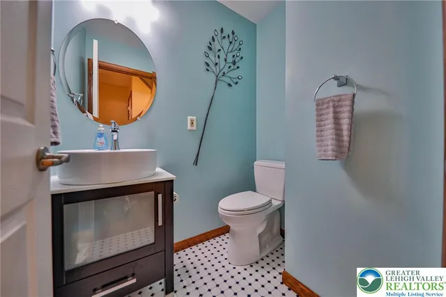 a bathroom with a granite countertop sink a mirror and a bathtub