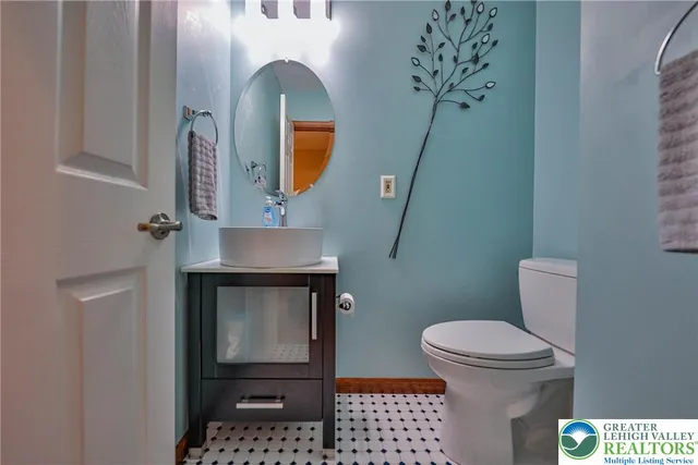 a bathroom with a granite countertop sink and a bathtub