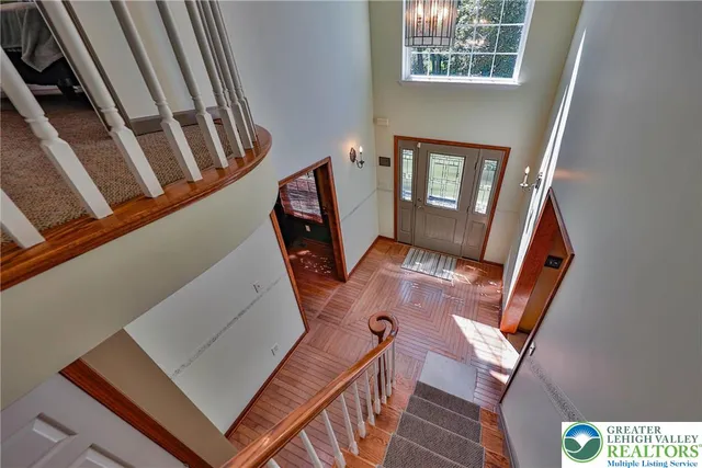 a view of an empty room with a chandelier fan