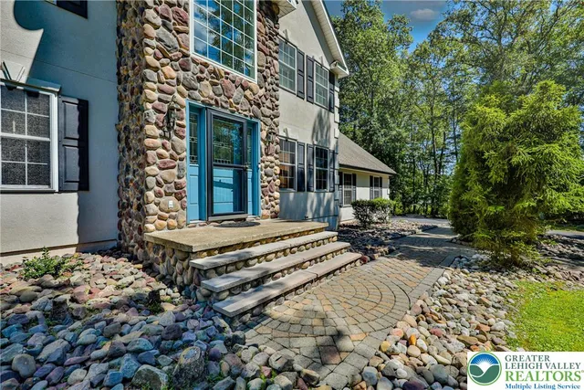a view of a patio with table and chairs and potted plants