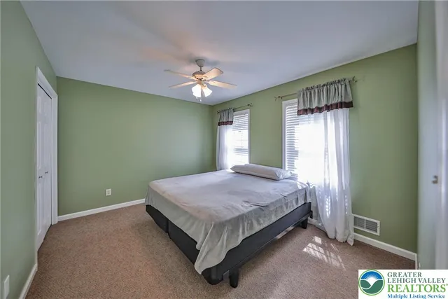 an aerial view of a house with a yard and trees