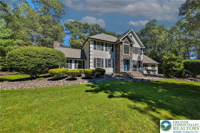 an aerial view of a house with yard swimming pool and outdoor seating