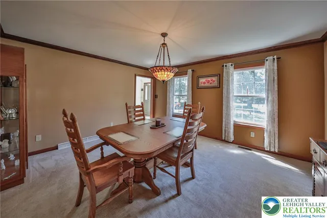 a dining room with furniture and window
