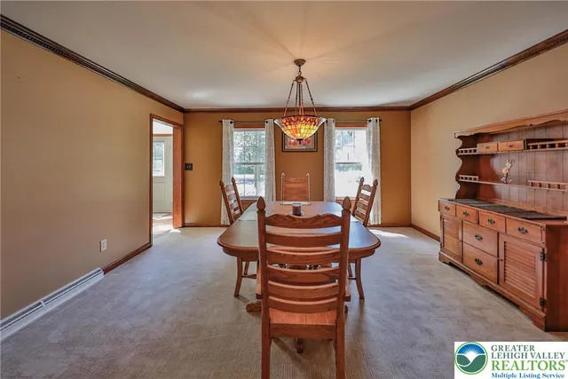 a kitchen with a refrigerator a stove top oven a sink dishwasher and a dining table with wooden floor