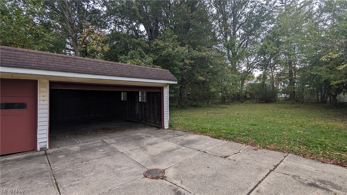 1470 Babbitt Road Euclid, OH 44117 - Photo 7 of 34 Garage featuring a lawn