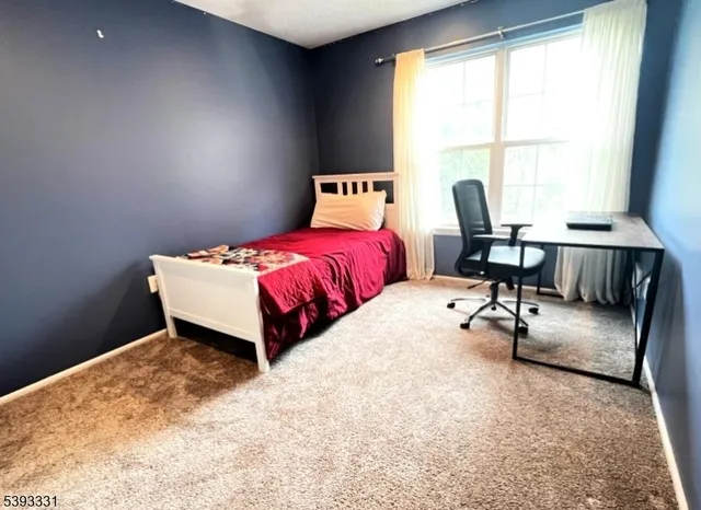 a bed room with a bed and a chair