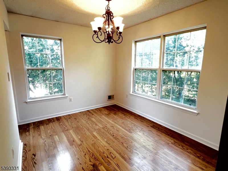 1007 Magnolia Lane Somerville, NJ 08876 - Photo 5 of 13 a view of an empty room with wooden floor and a window