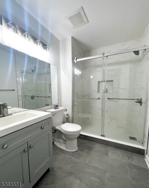 1007 Magnolia Lane Somerville, NJ 08876 - Photo 10 of 13 a bathroom with a double vanity sink toilet and shower