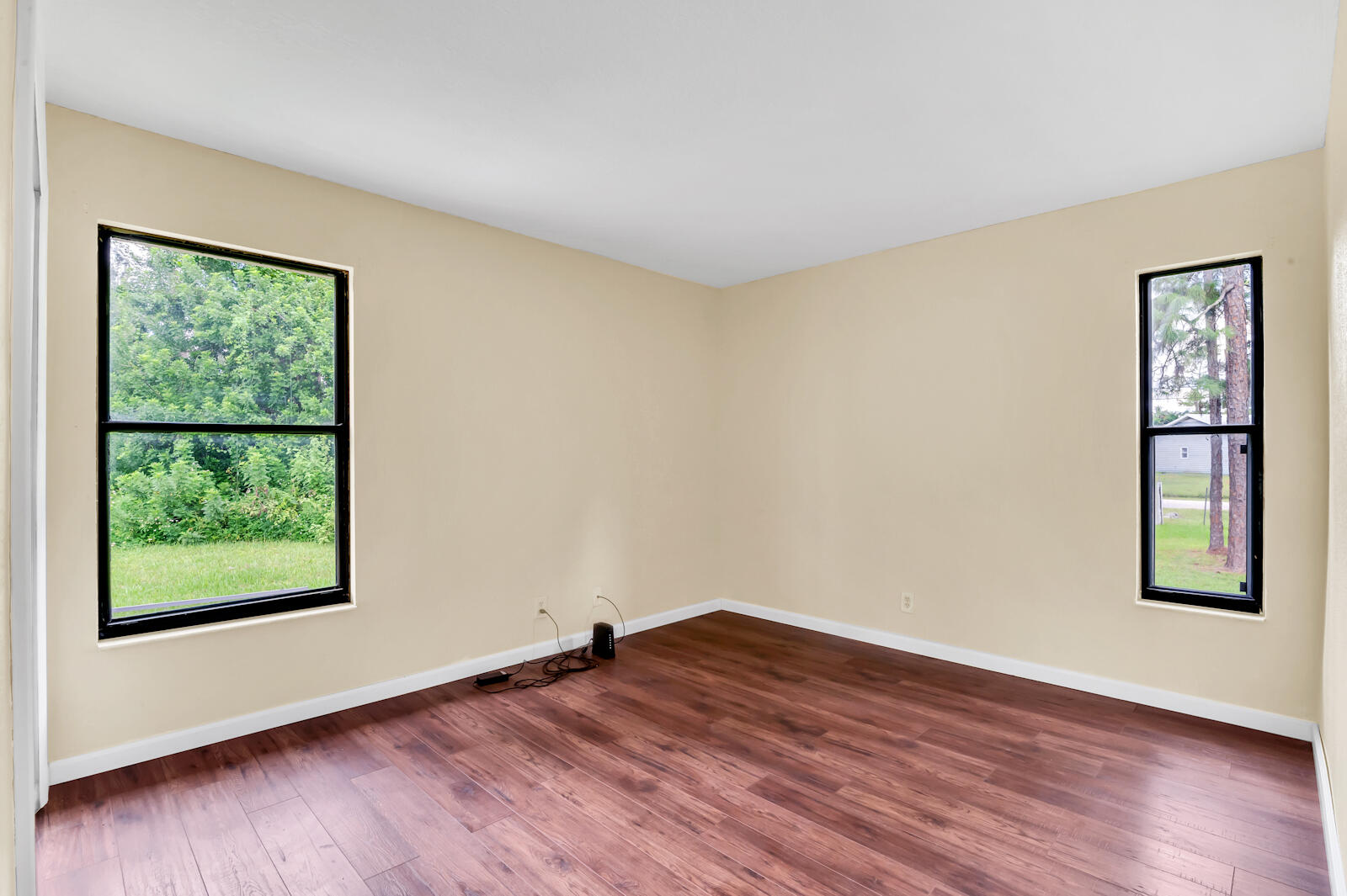 4091 Mandarin Boulevard Loxahatchee, FL 33470 - Photo 16 of 31 an empty room with wooden floor and windows