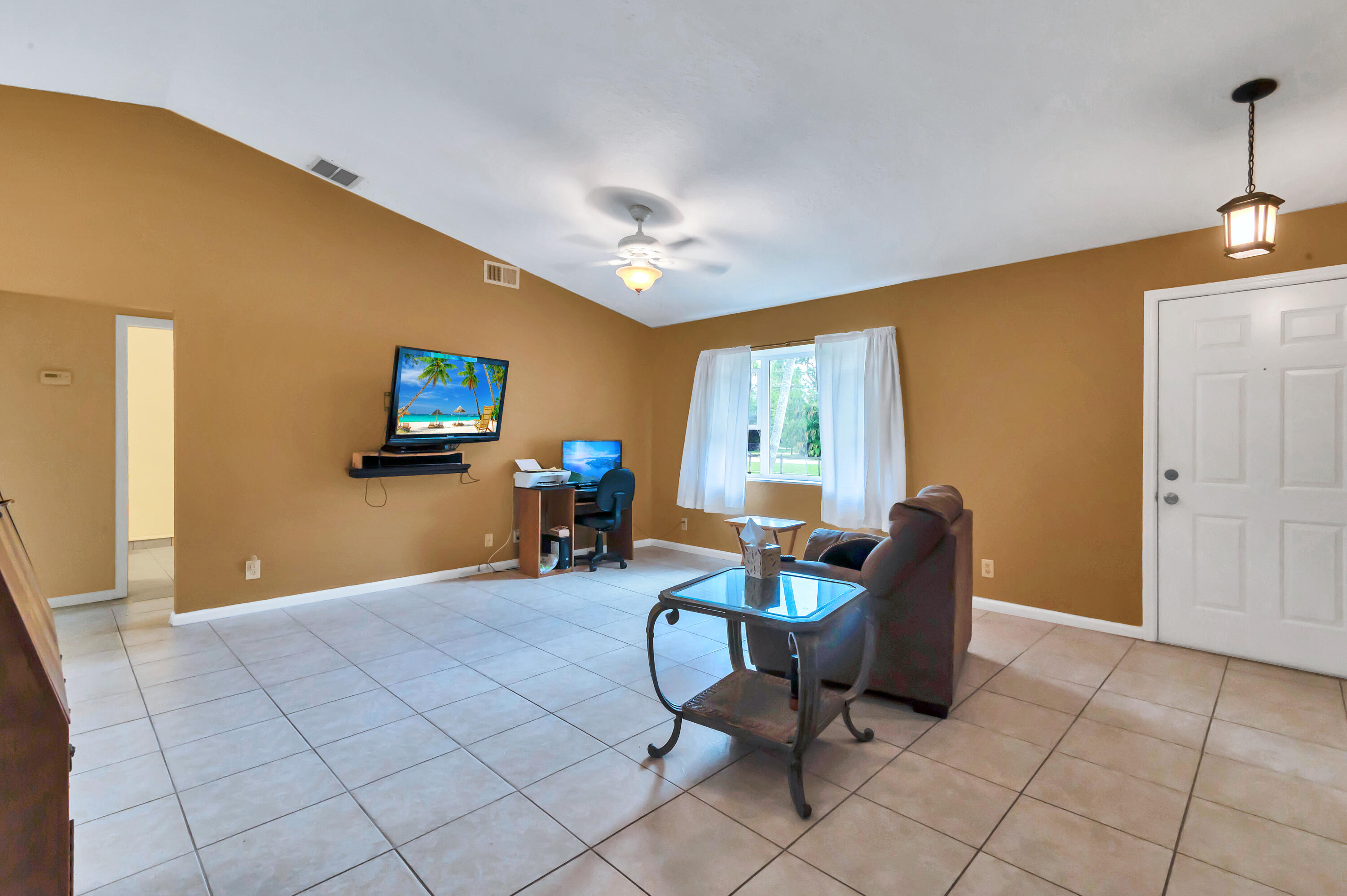 4091 Mandarin Boulevard Loxahatchee, FL 33470 - Photo 7 of 31 a view of a livingroom with workspace and a window