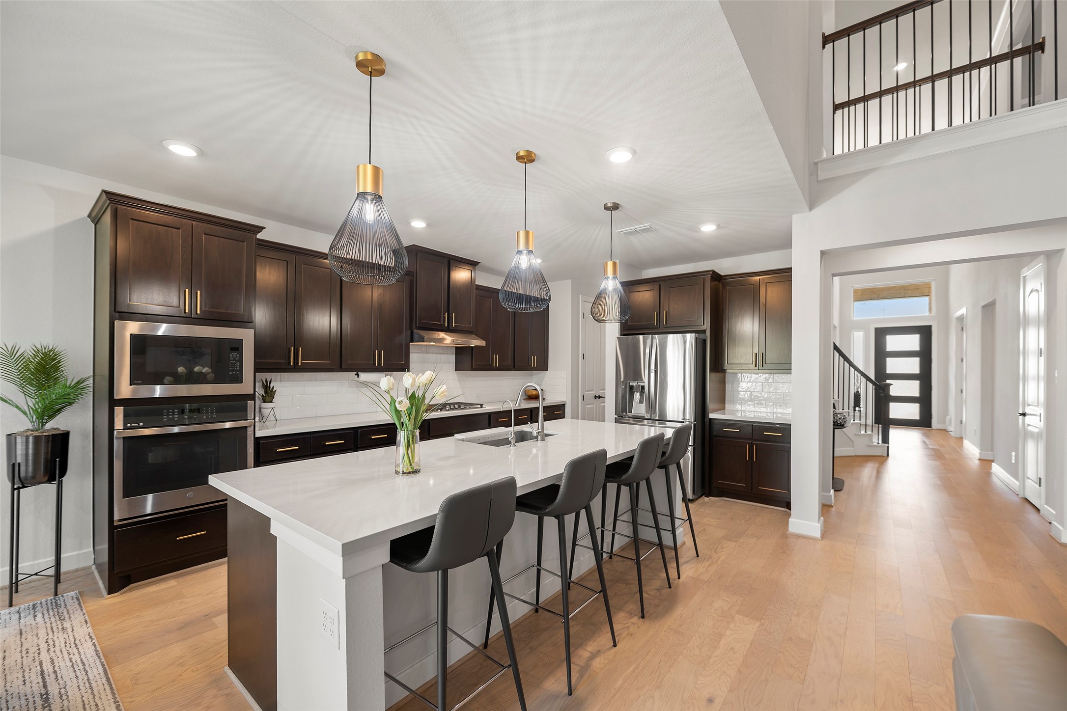4802 Pecos Ridge Lane Sugar Land, TX 77479 - Photo 15 of 48 a kitchen with stainless steel appliances kitchen island granite countertop a sink a stove and a refrigerator
