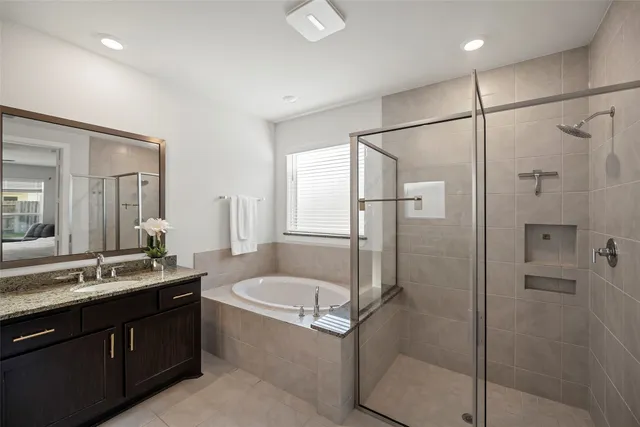 a bathroom with a granite countertop sink mirror bathtub and shower