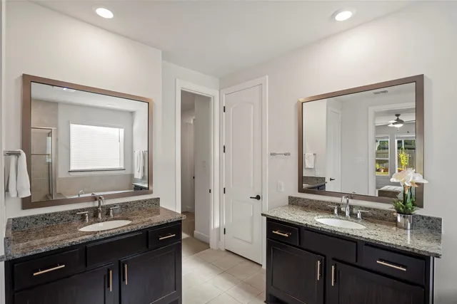 a bathroom with a granite countertop sink double and mirror