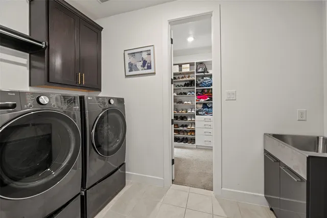 a view of a storage and utility room with washer and dryer