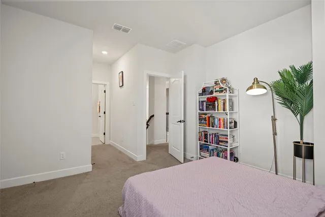 a bedroom with a bed and a book shelf