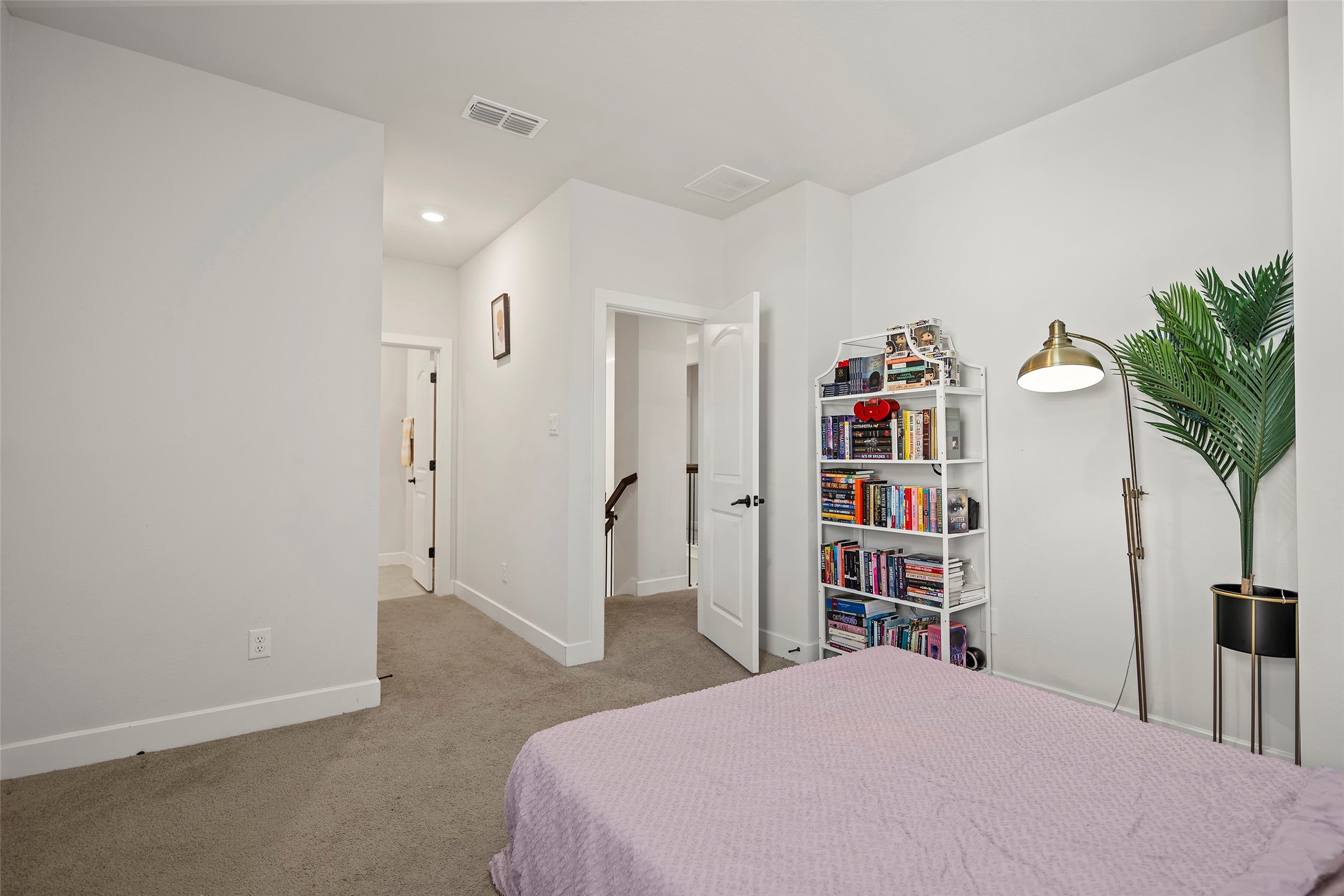 4802 Pecos Ridge Lane Sugar Land, TX 77479 - Photo 27 of 48 a bedroom with a bed and a book shelf