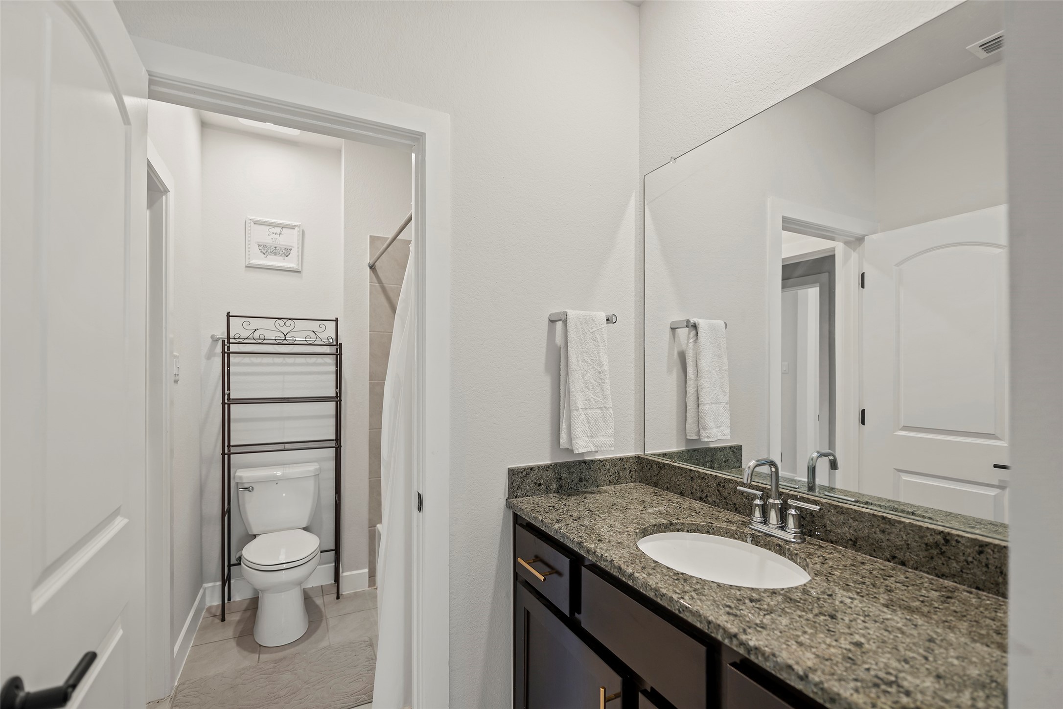 4802 Pecos Ridge Lane Sugar Land, TX 77479 - Photo 32 of 48 a bathroom with a granite countertop sink toilet and a mirror