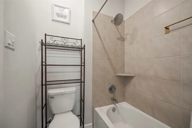 a bathroom with a toilet a sink and bathtub