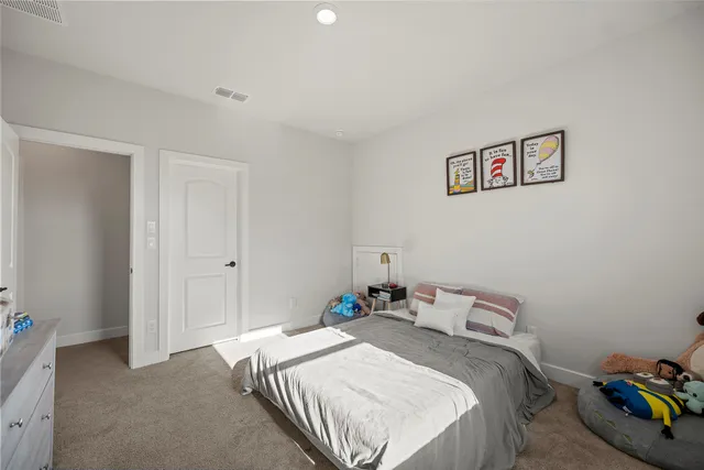 a bedroom with a bed and a wall painting