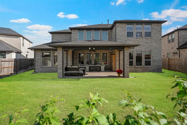 a view of a house with pool and a yard