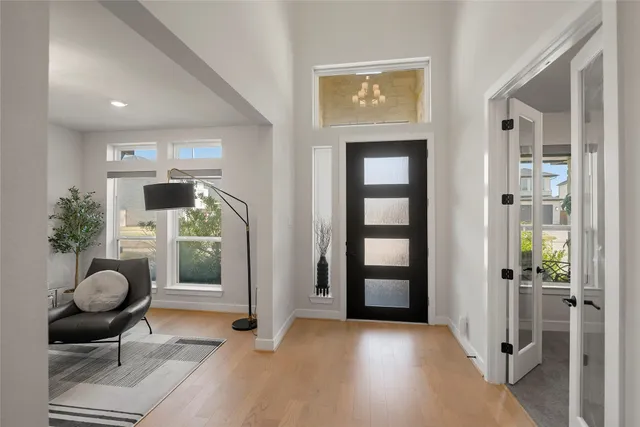a view of a livingroom with wooden floor and furniture