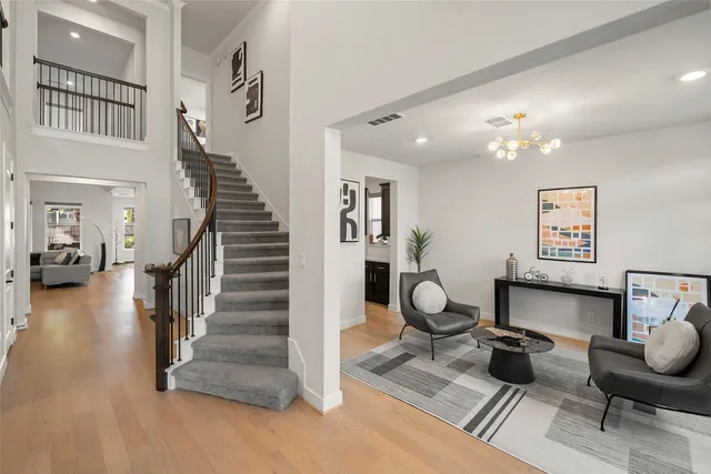 a living room with furniture and stairs