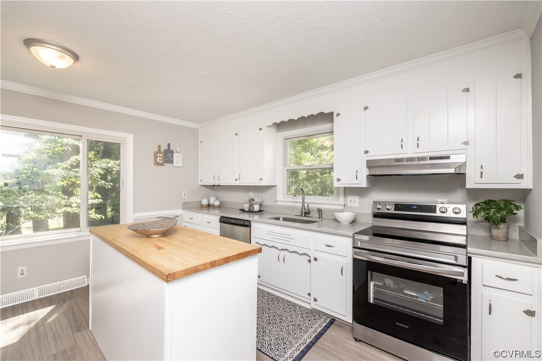 4531 Crossgate Road Chester, VA 23831 - Photo 14 of 37 a kitchen with a stove a sink and a window