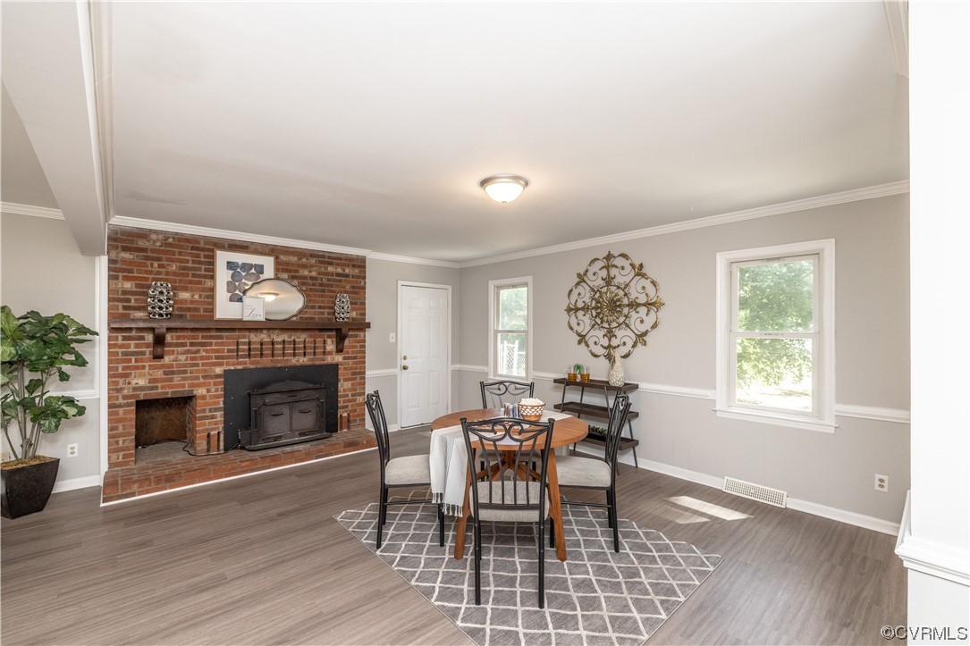4531 Crossgate Road Chester, VA 23831 - Photo 6 of 37 a dining room with furniture a fireplace and wooden floor