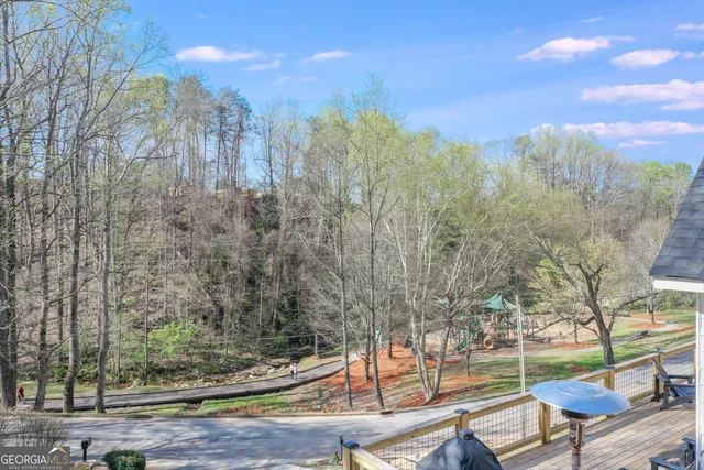 a view of a yard with plants and a bench