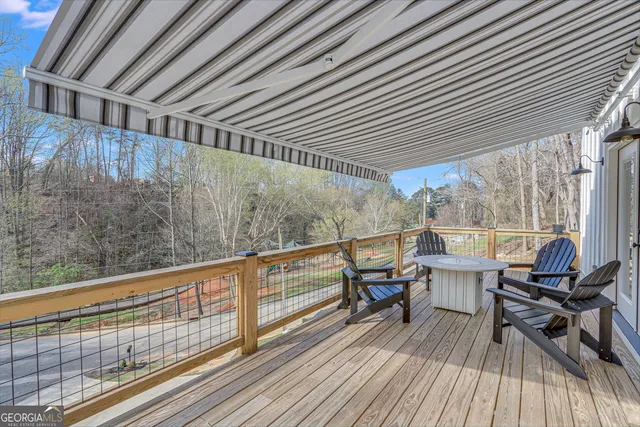 a view of a balcony with chairs and wooden floor