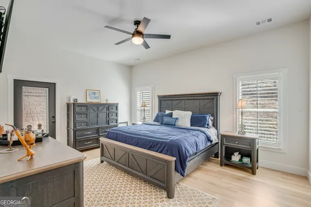 a bedroom with a bed and a chandelier
