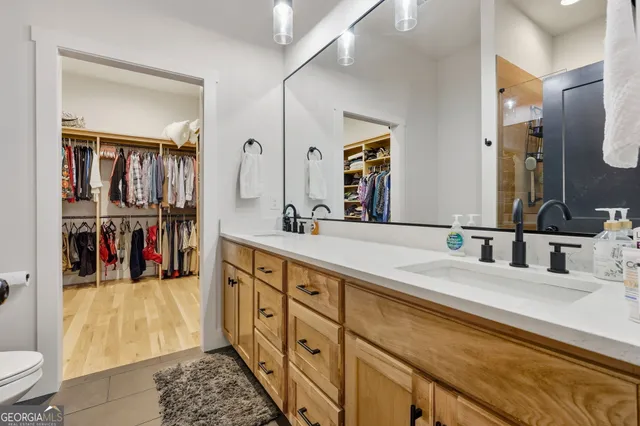 a bathroom with a double vanity sink and a mirror