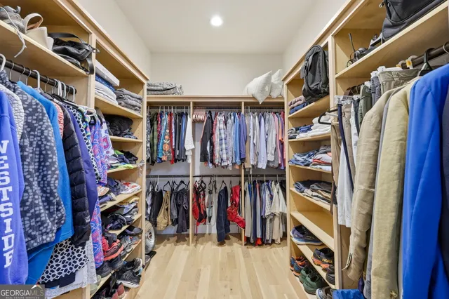 a view of walk in closet with clothes