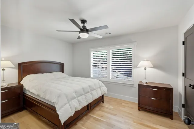 a bedroom with a bed and a ceiling fan