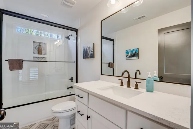 a bathroom with a sink toilet and shower