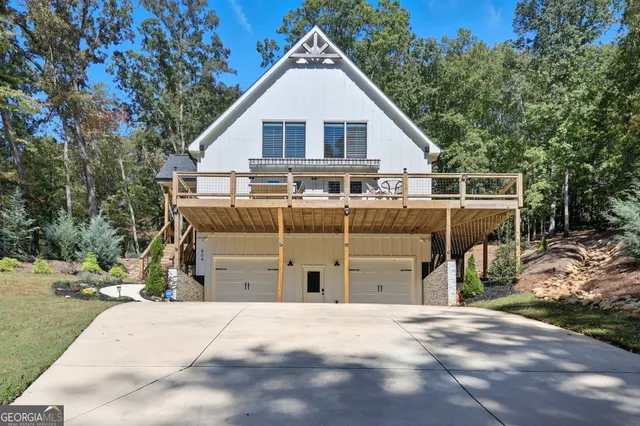 a view of a house with wooden fence