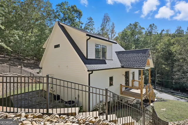 a view of a house with backyard and sitting area