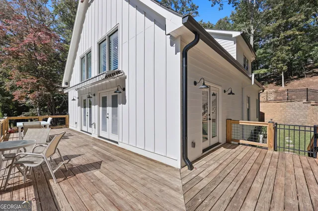a view of balcony with wooden floor and trees