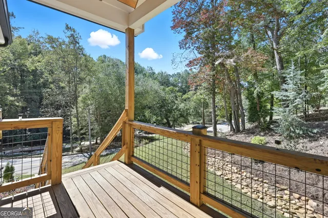 a view of balcony with wooden floor and fence