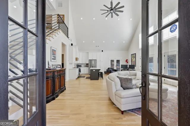 a living room with furniture a fireplace and a large window