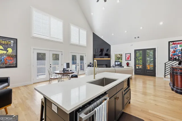 a kitchen with stainless steel appliances granite countertop a sink a stove and a refrigerator