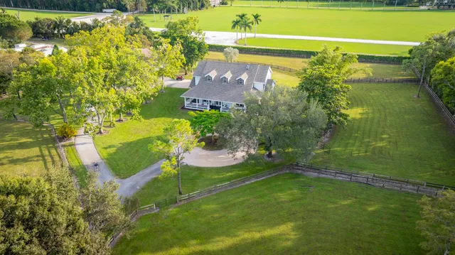 a view of a house with swimming pool and a yard