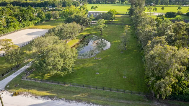 a living room with furniture and view of kitchen