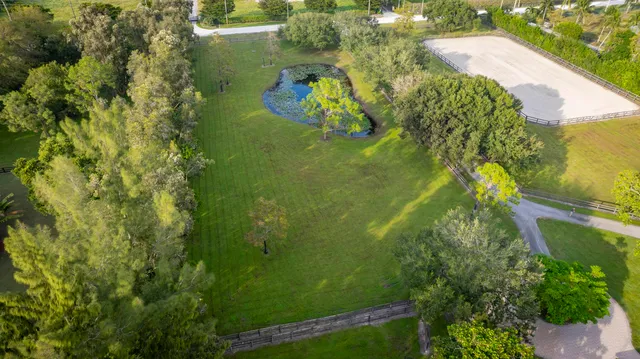 an aerial view of residential houses with outdoor space and river